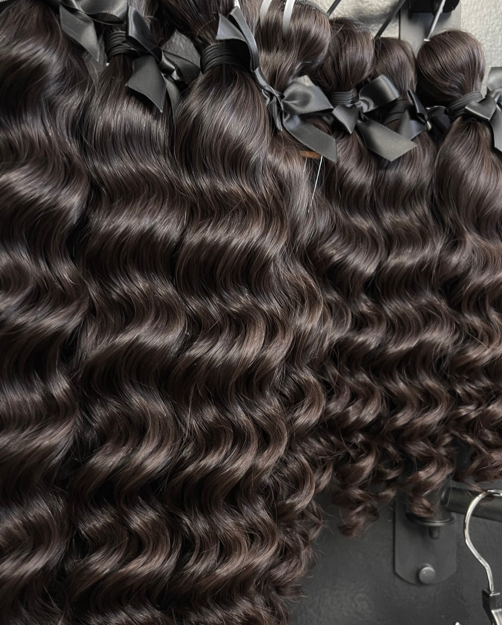Raw Water Wave hair extensions with wavy texture on a black background
