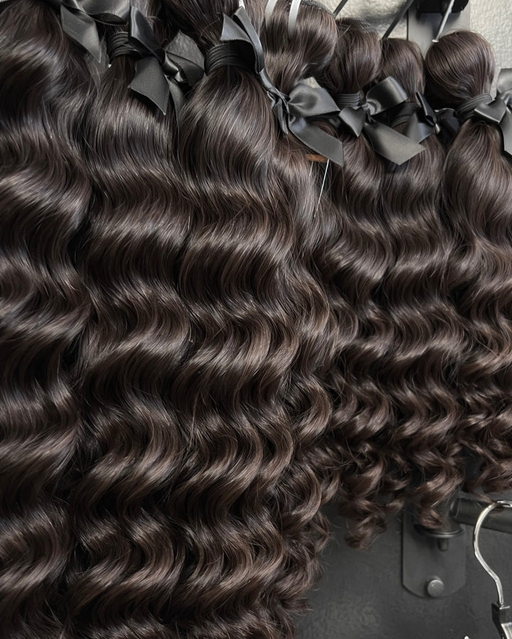 Raw Water Wave hair extensions with wavy texture on a black background