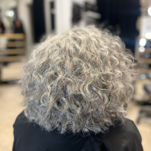 customer wearing  gray-wavy-raw-hair-bundles